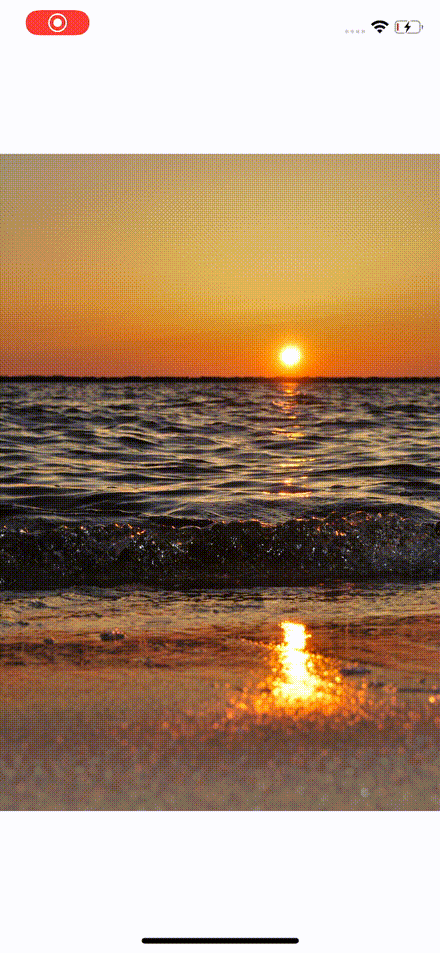 A photographic image of the sun setting over the sea